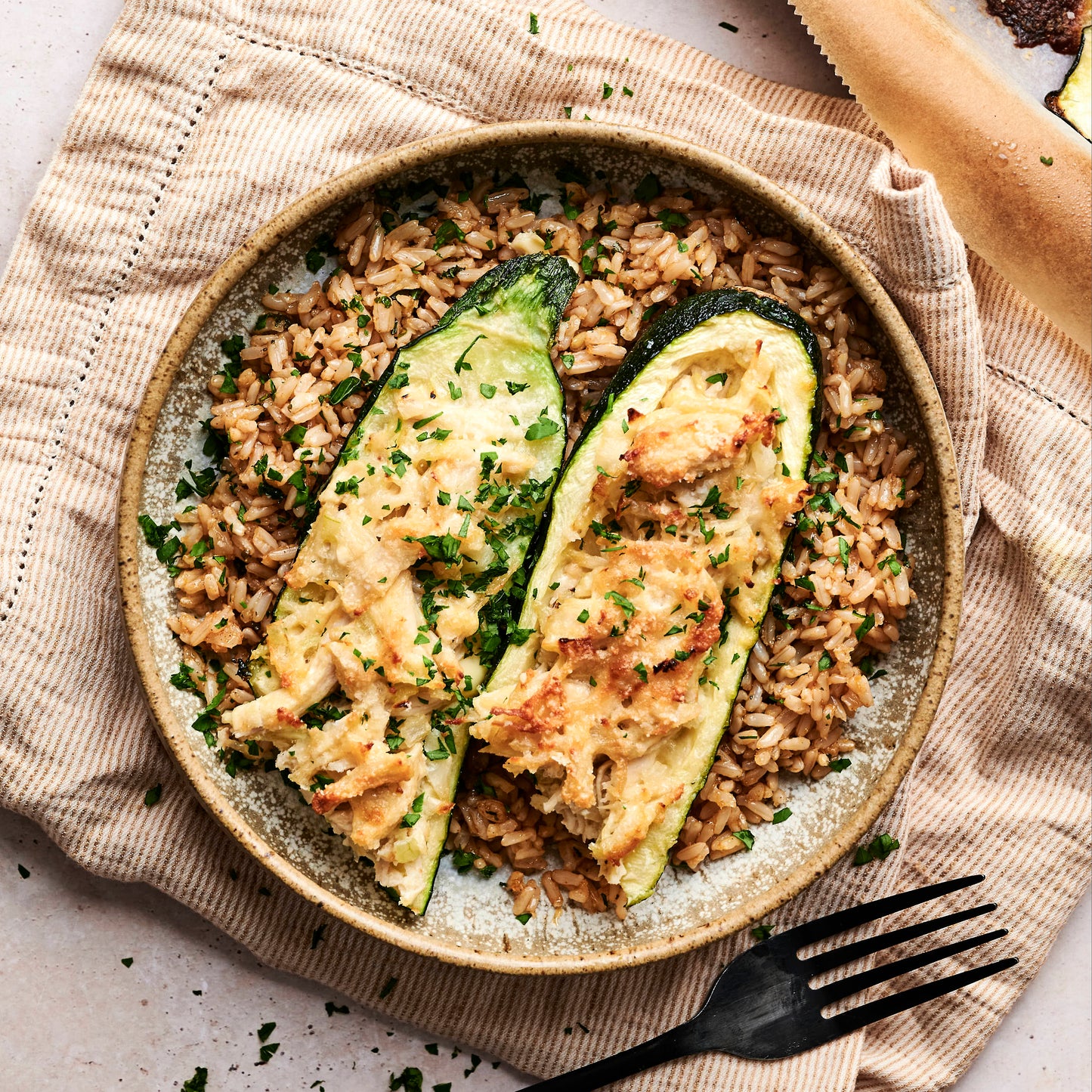 Calabacín relleno de pollo desmenuzado acompañado de arroz integral
